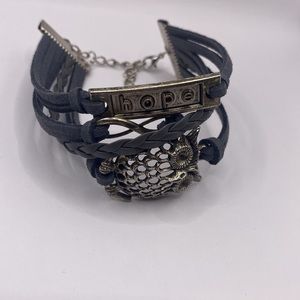 Gray leather like bracelet with owl